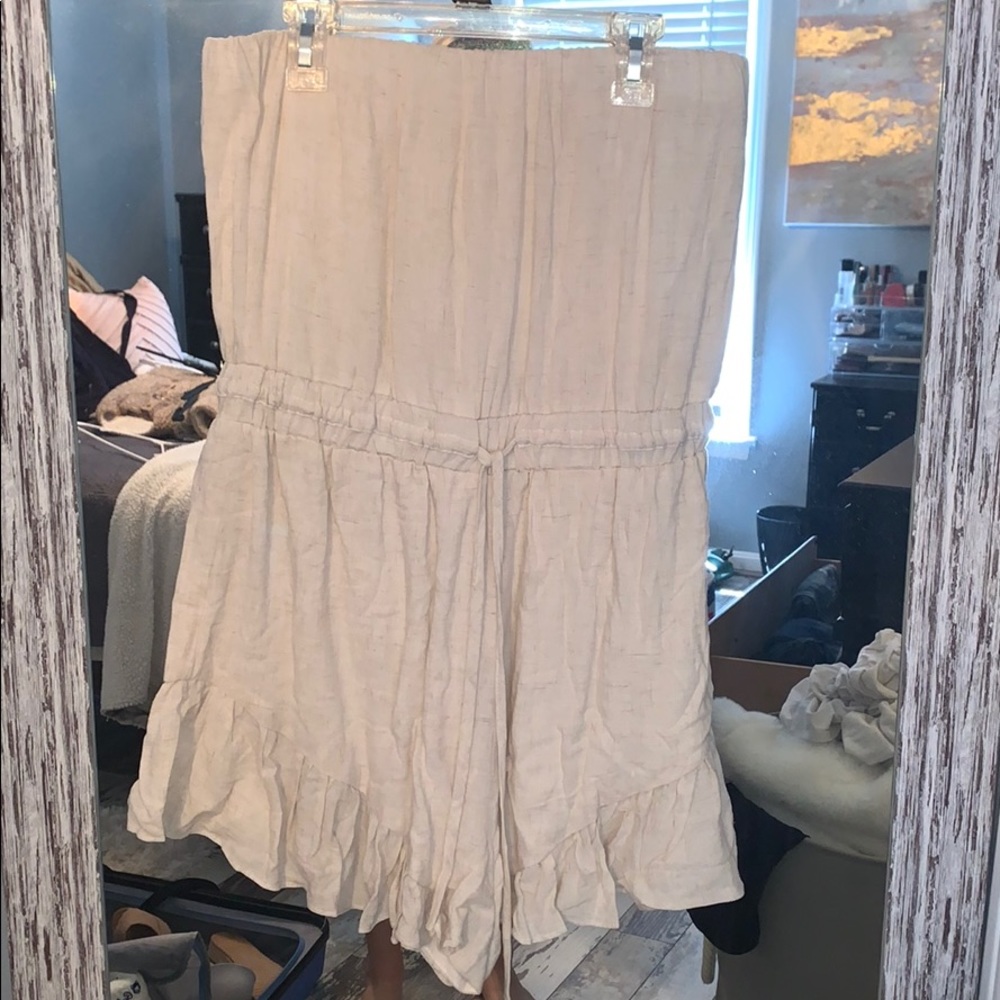 Tan romper with ruffle bottom detail